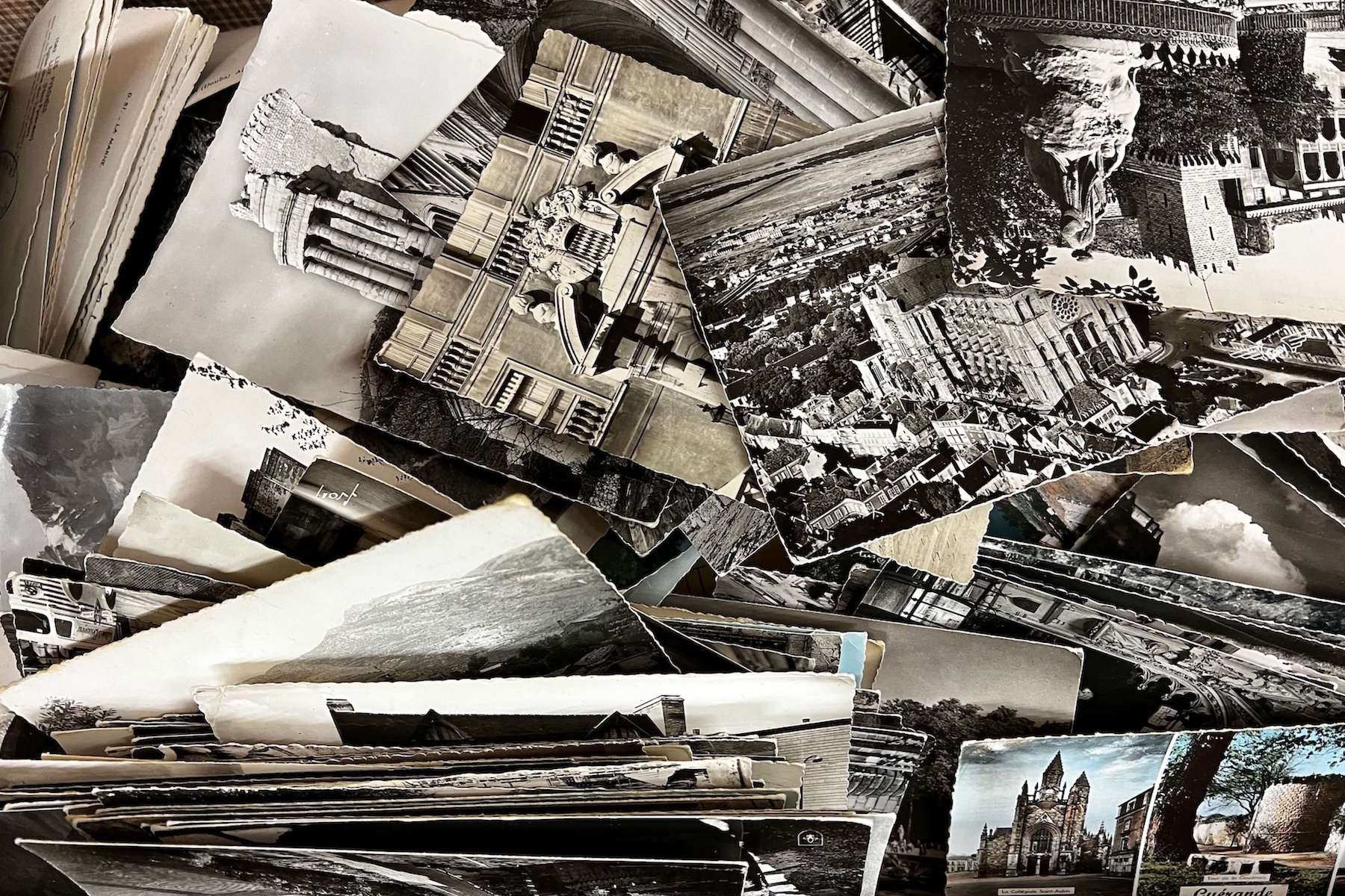 An assortment of vintage black-and-white postcards featuring architectural landmarks, including the Colosseum and a castle, showcasing historical structures and scenic landscapes.